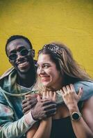 Portrait of happy couple in front of yellow wall photo